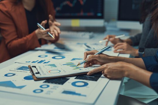 Team reviewing business reports and charts